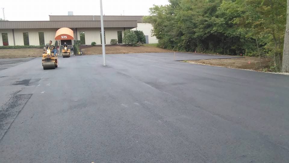 A road is being paved in front of a building.