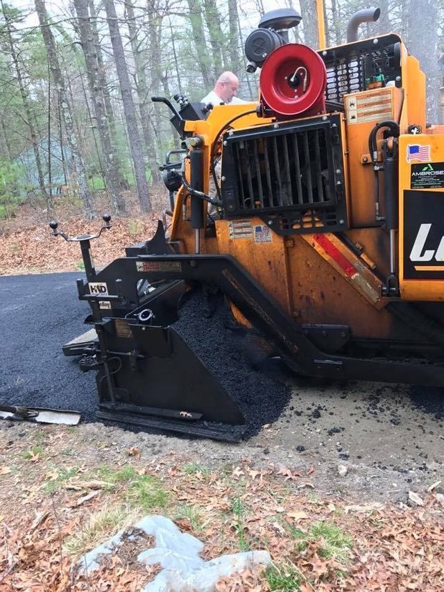 A yellow tractor with the letter l on the side of it