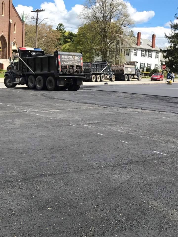 A dump truck is parked in a parking lot