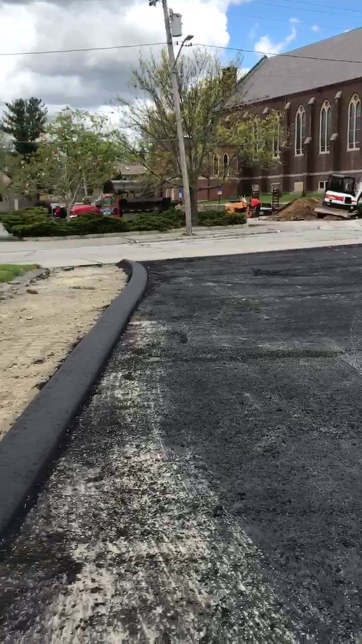 A large building is being built on the side of a road.