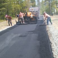 A group of people are working on a road.