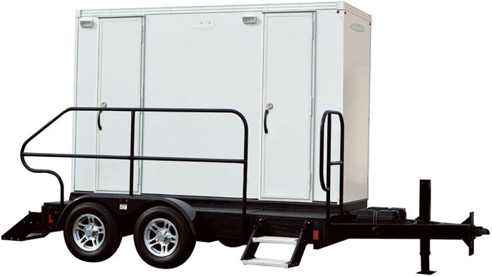 Portable restroom trailer with two stalls, mounted on a black trailer with wheels and a small staircase.