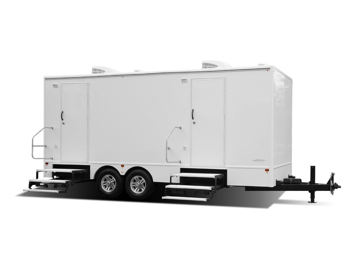 White mobile restroom trailer with two axles and steps.