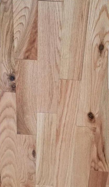 Light-colored hardwood flooring with wood grain and knots.