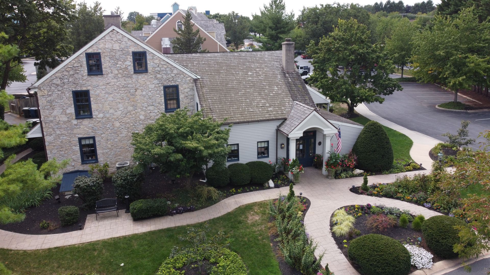 An aerial view of a large house with a walkway leading to it