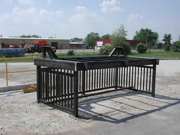 A large metal structure is sitting on the side of the road