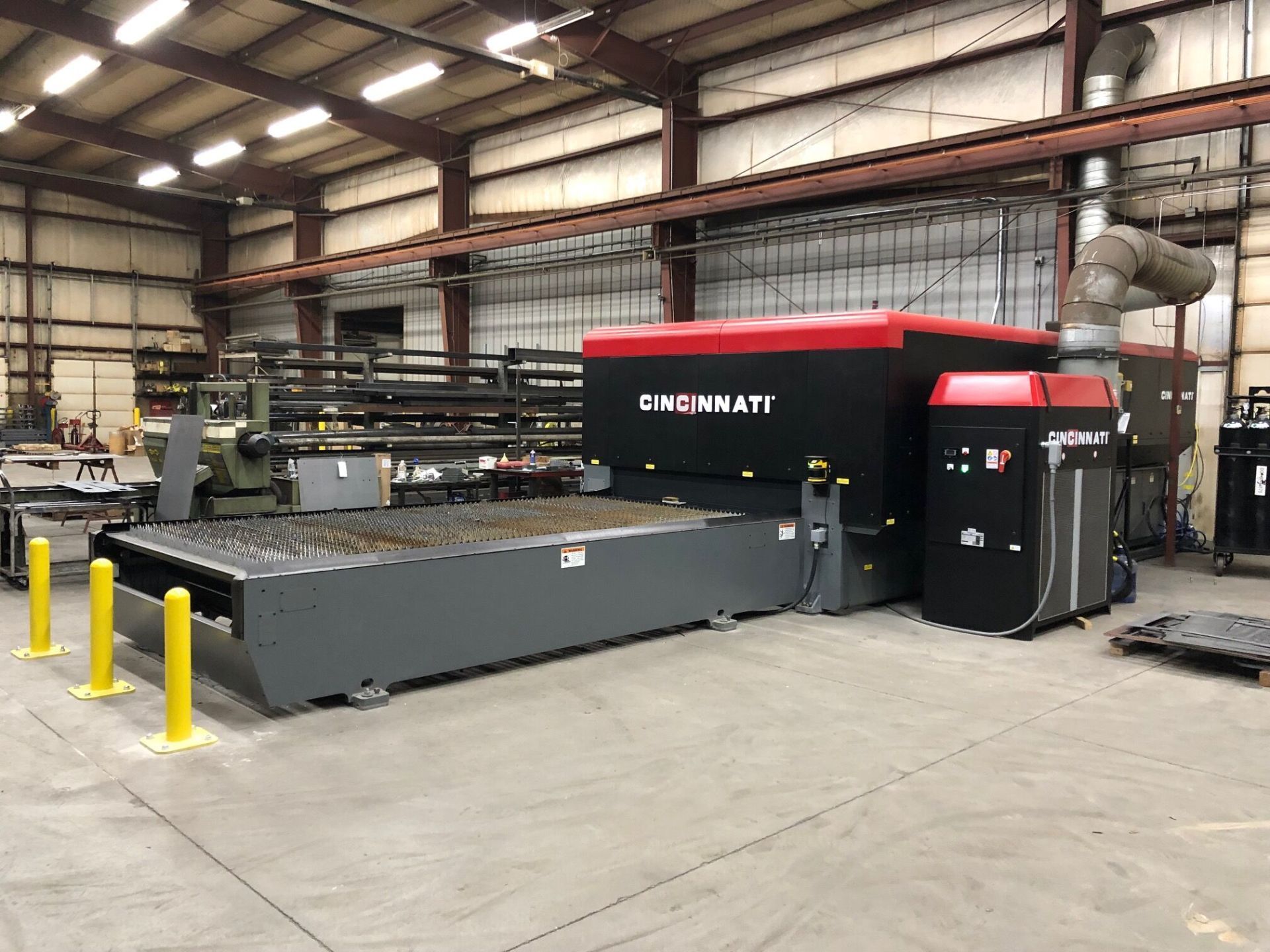 A large machine is sitting in a large warehouse.