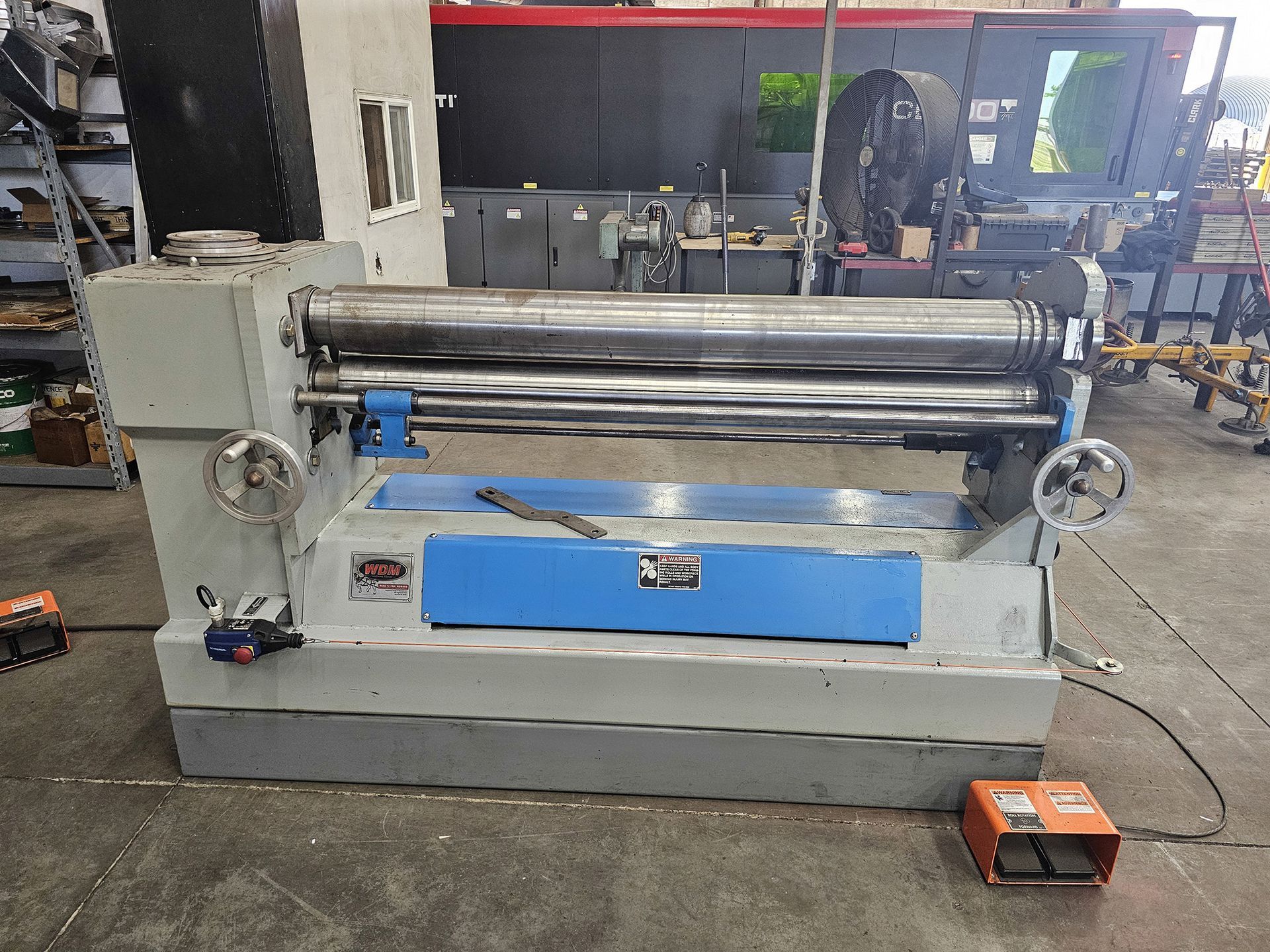 A machine is sitting on the floor in a factory.