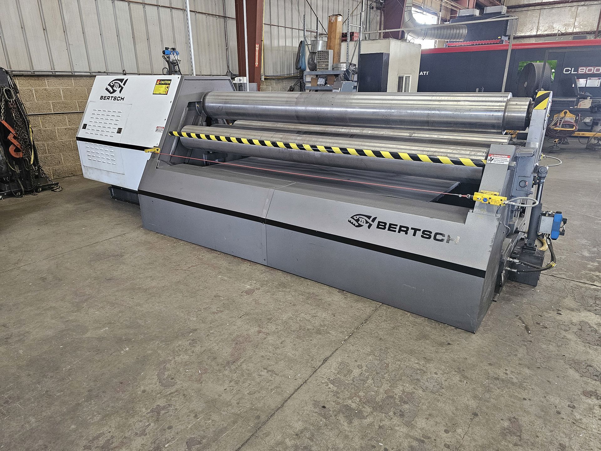 A large machine is sitting in a warehouse.