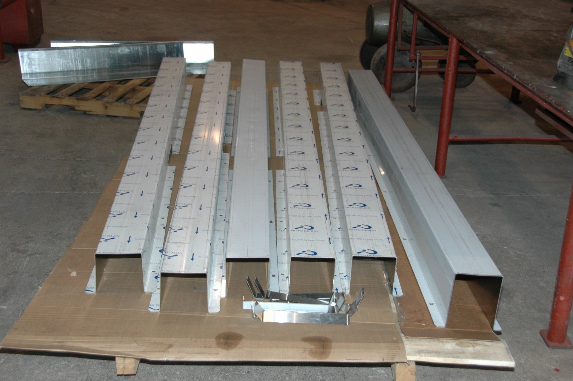 A bunch of metal pieces on a cardboard pallet