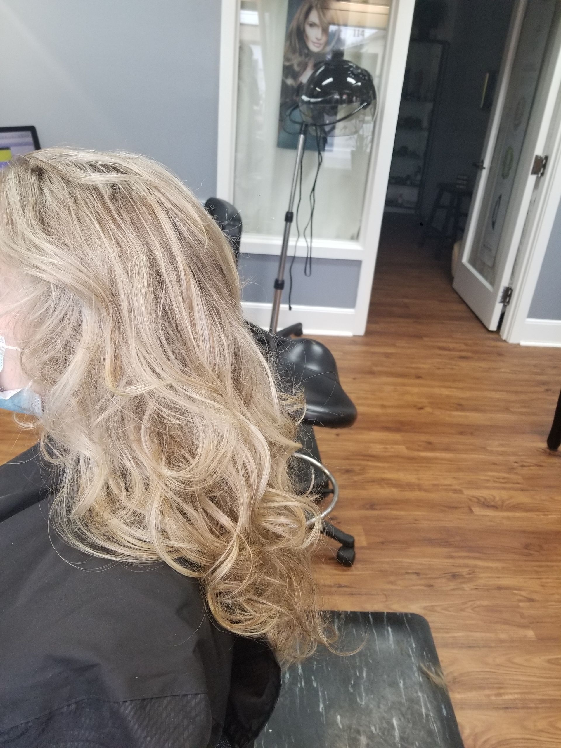 A woman is getting her hair done in a salon.