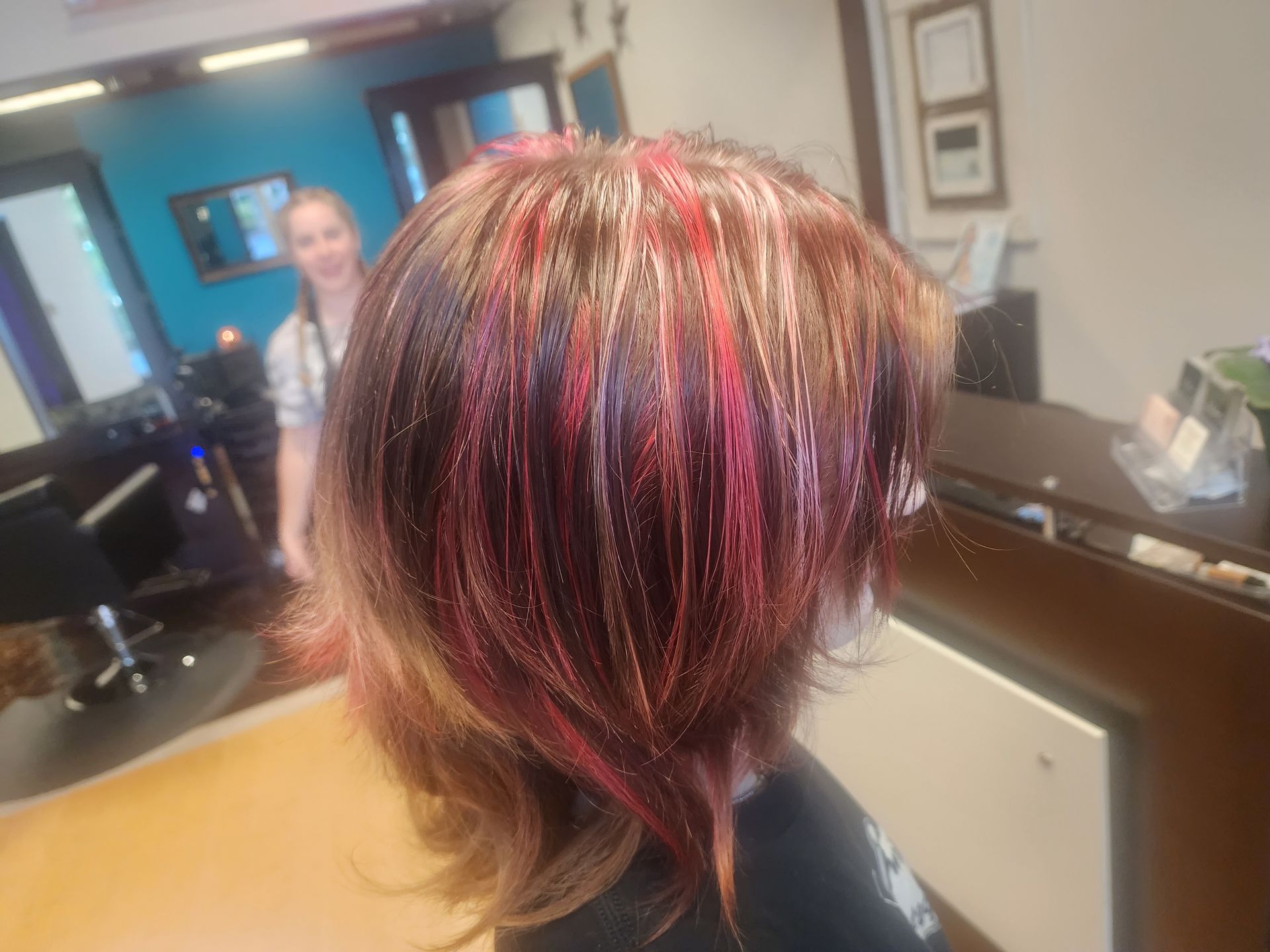 A woman is getting her hair dyed in a salon.