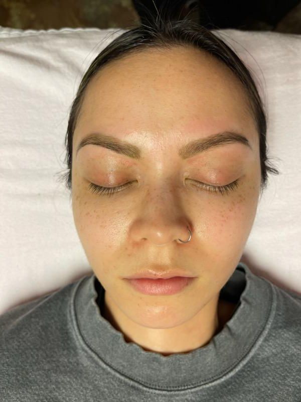 A close up of a woman 's face with her eyes closed.