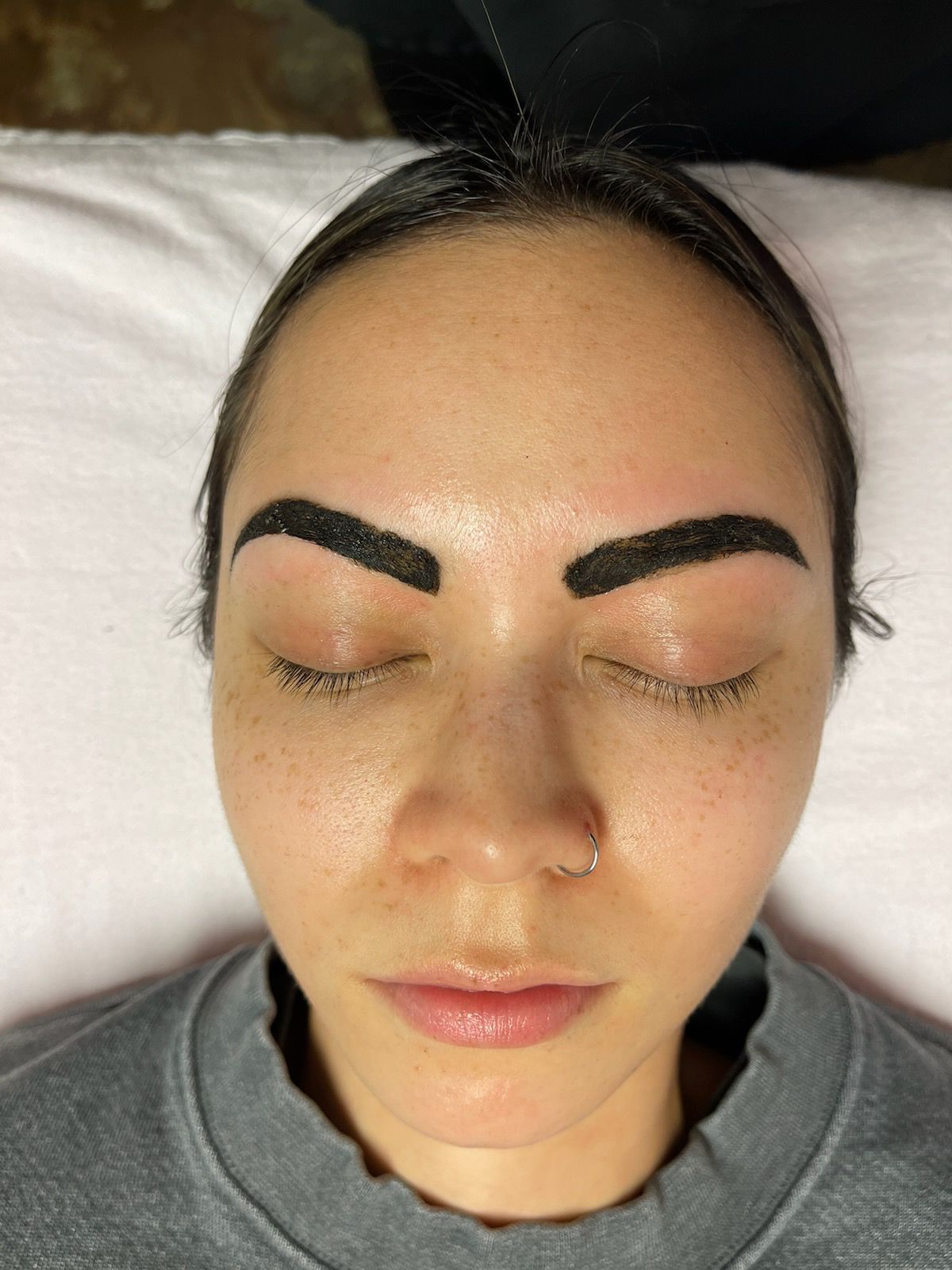 A close up of a woman 's face with her eyes closed.