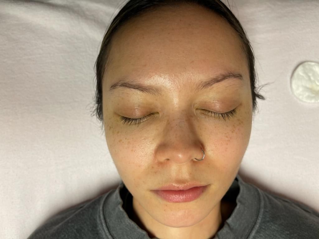 A close up of a woman 's face with her eyes closed.