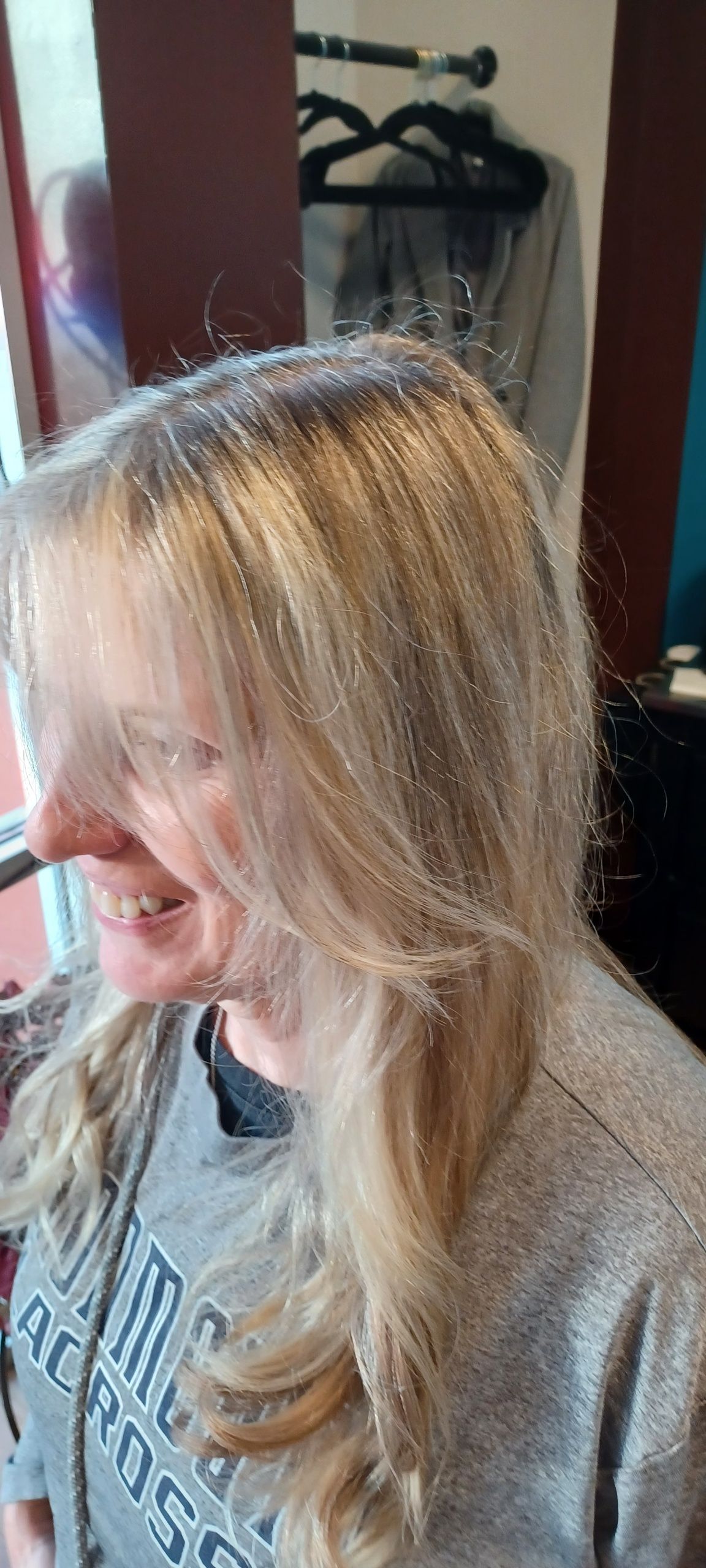 A woman is getting her hair done in a salon.