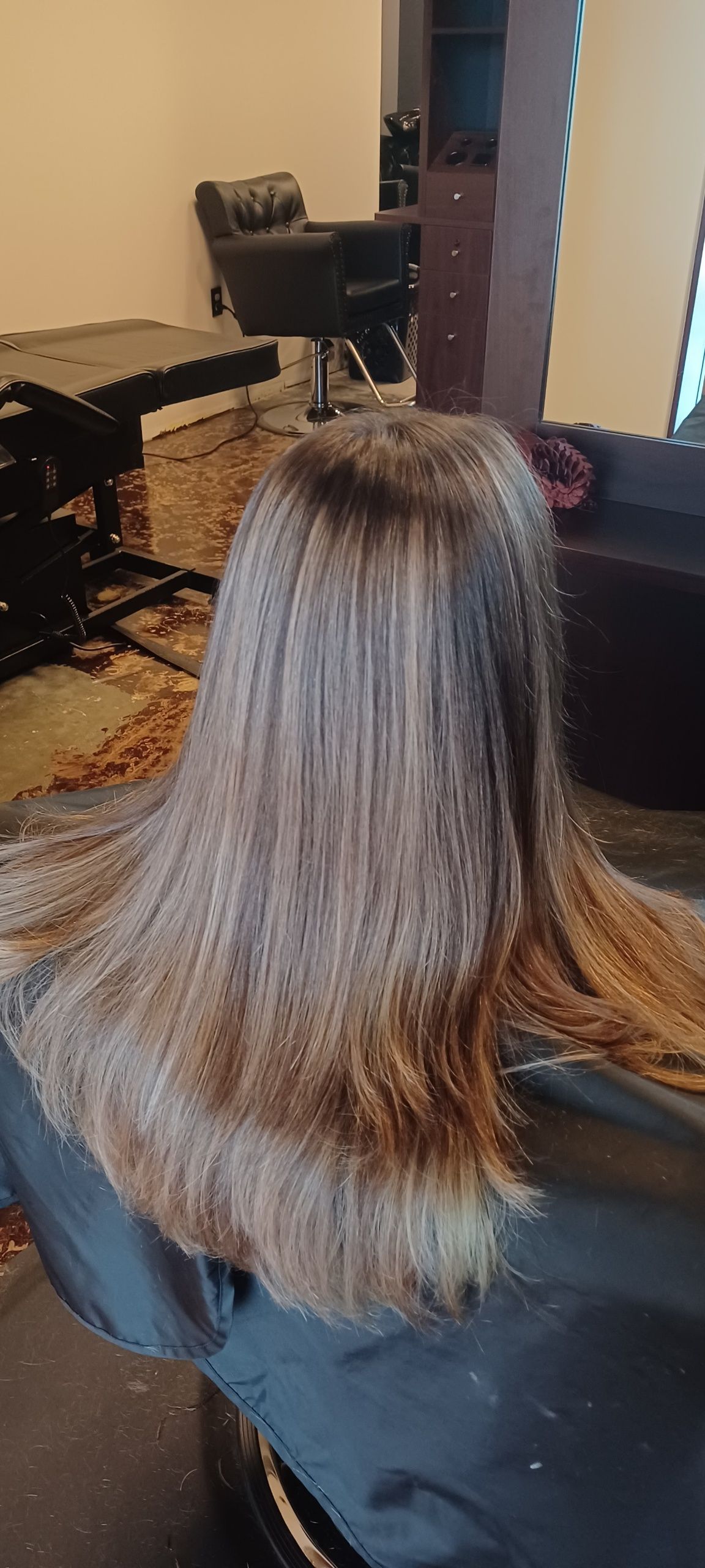 A woman is getting her hair cut in a salon.