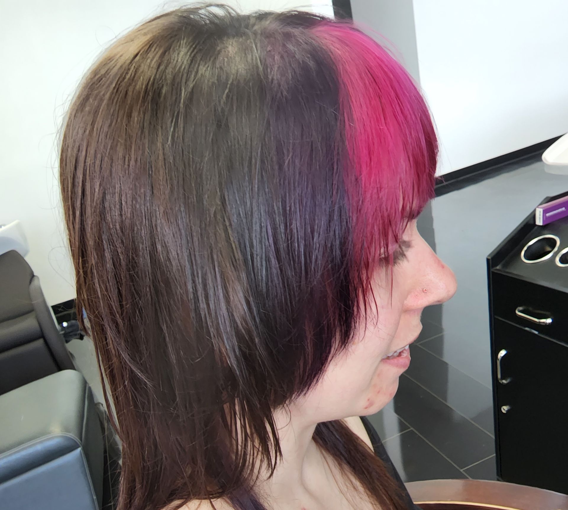 A woman with a pink streak in her hair