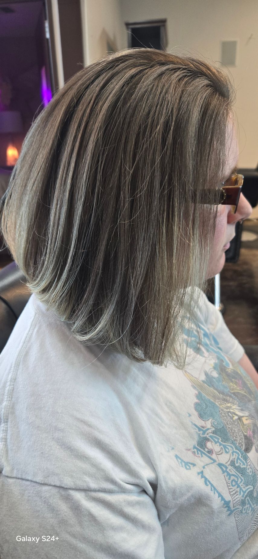 A woman is getting her hair done in a salon.