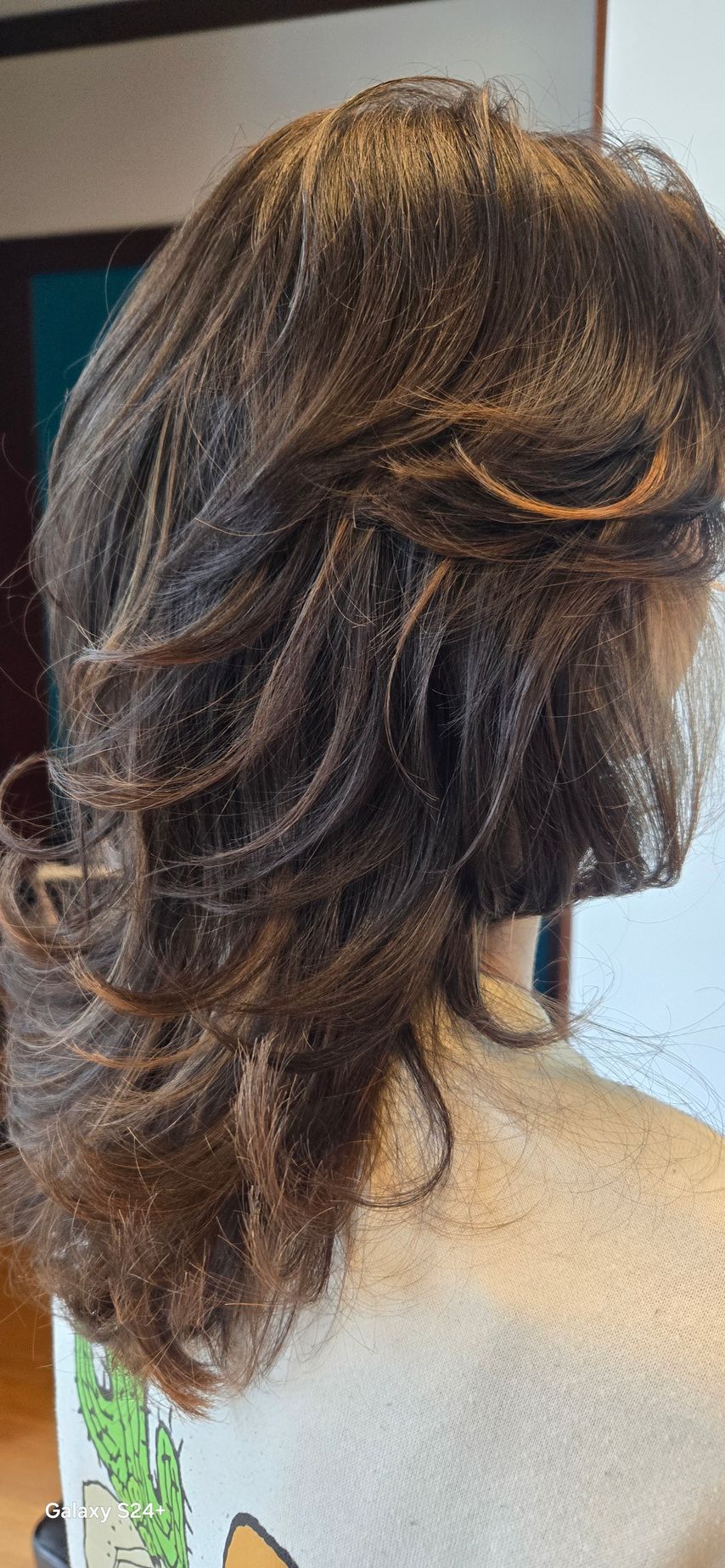 A close up of a woman 's hair in a half up half down hairstyle.