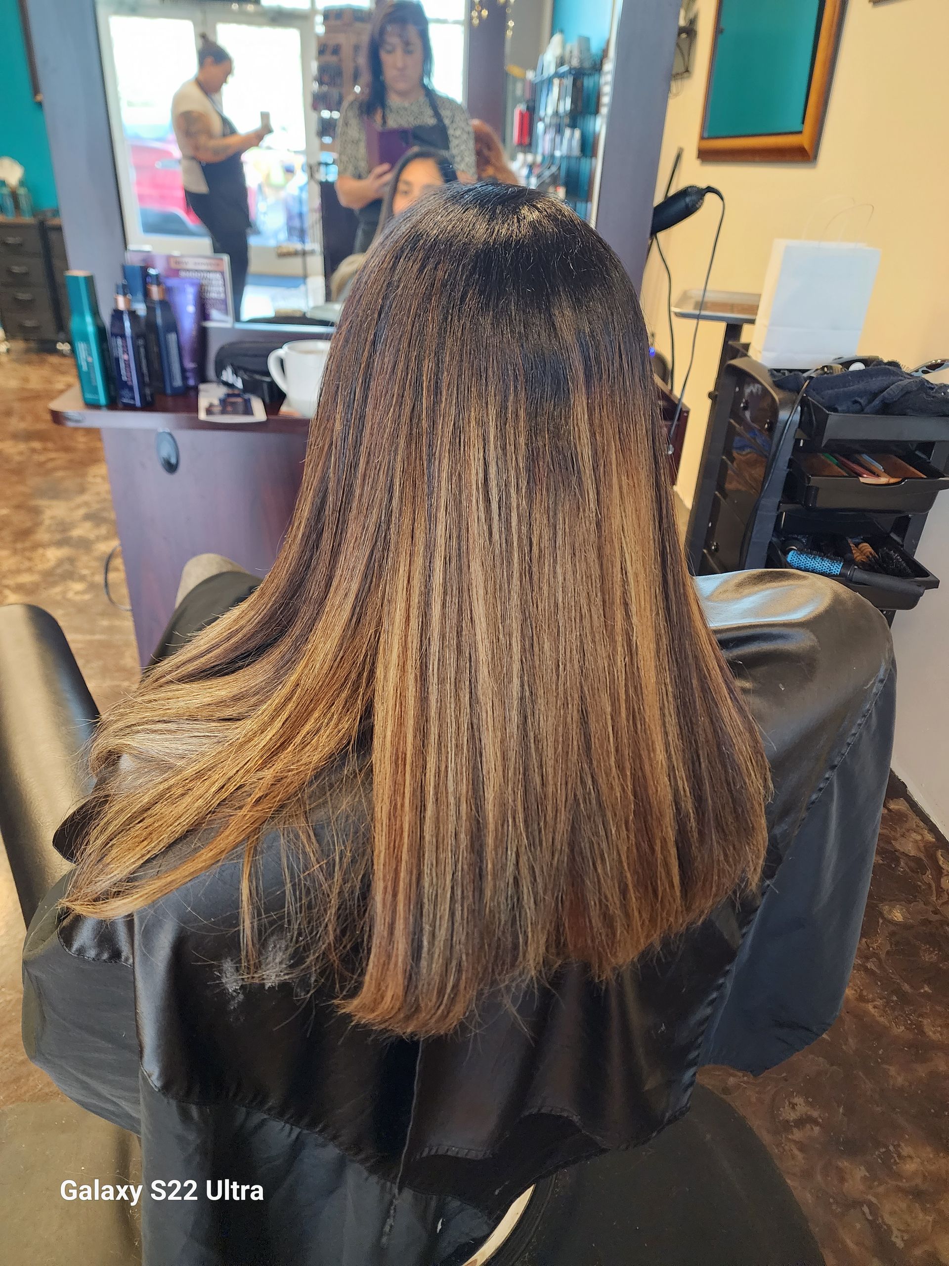 A woman is getting her hair dyed in a salon.