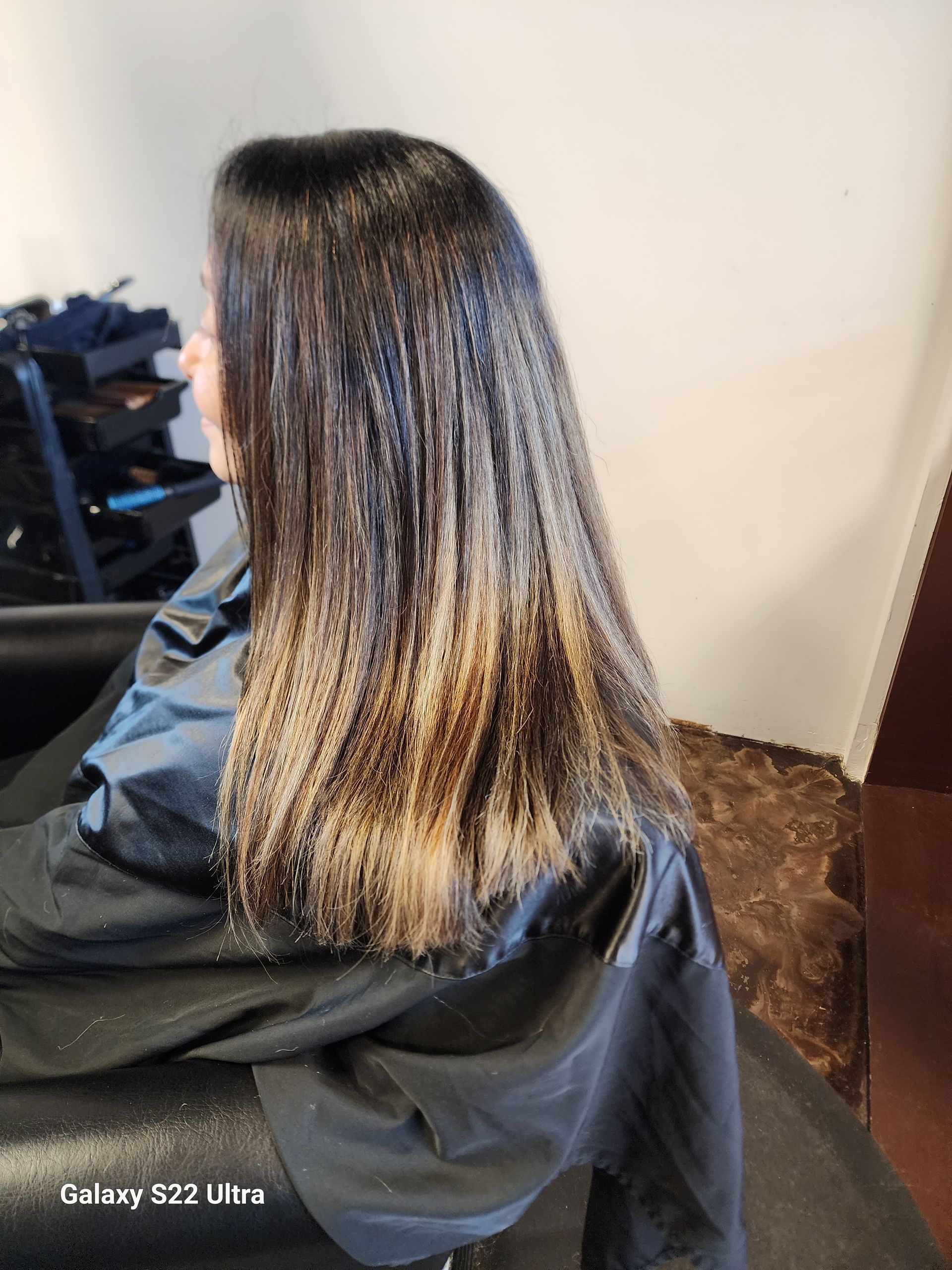 A woman is getting her hair dyed in a salon.