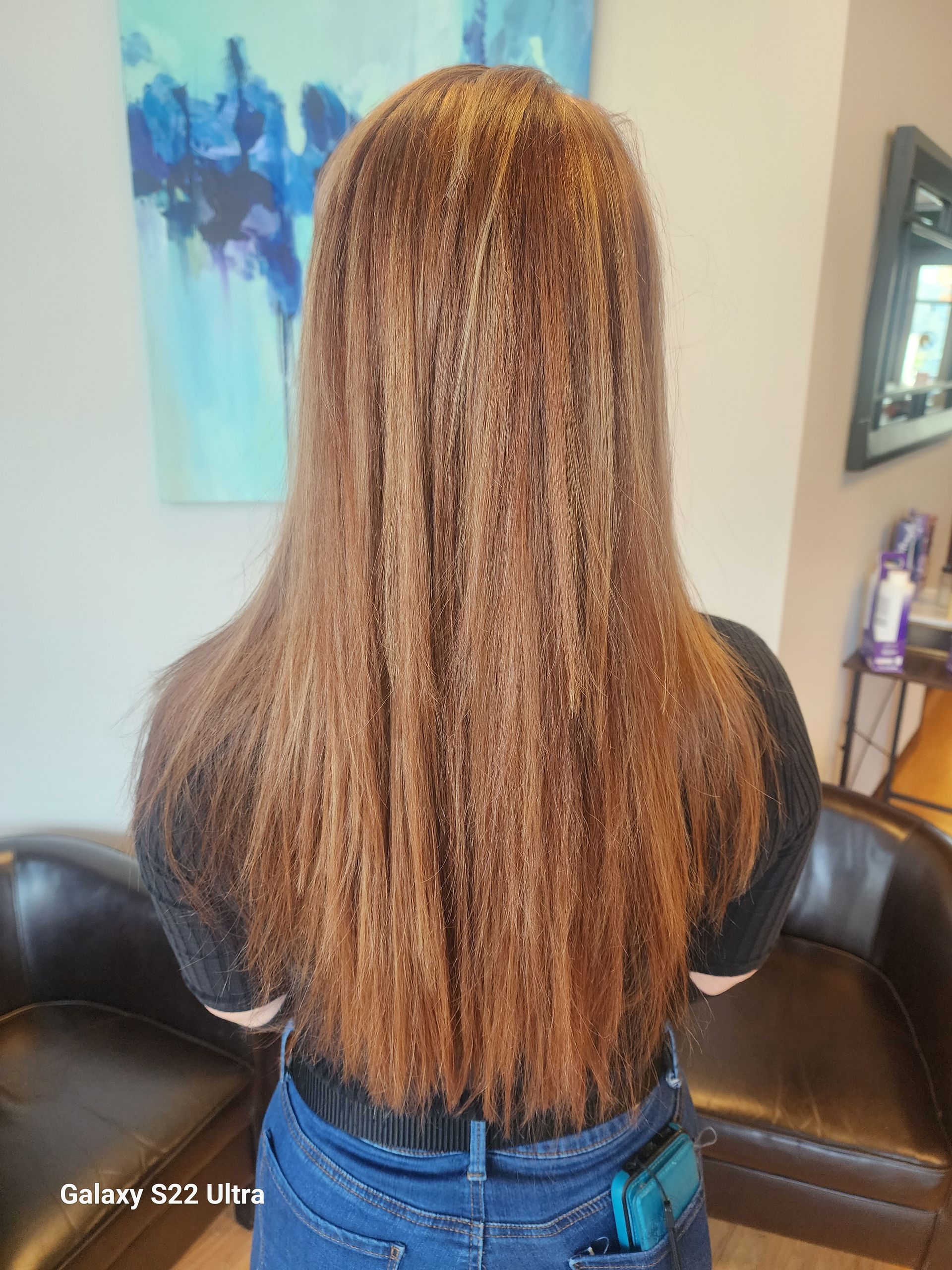 A woman with long brown hair is standing in a room.