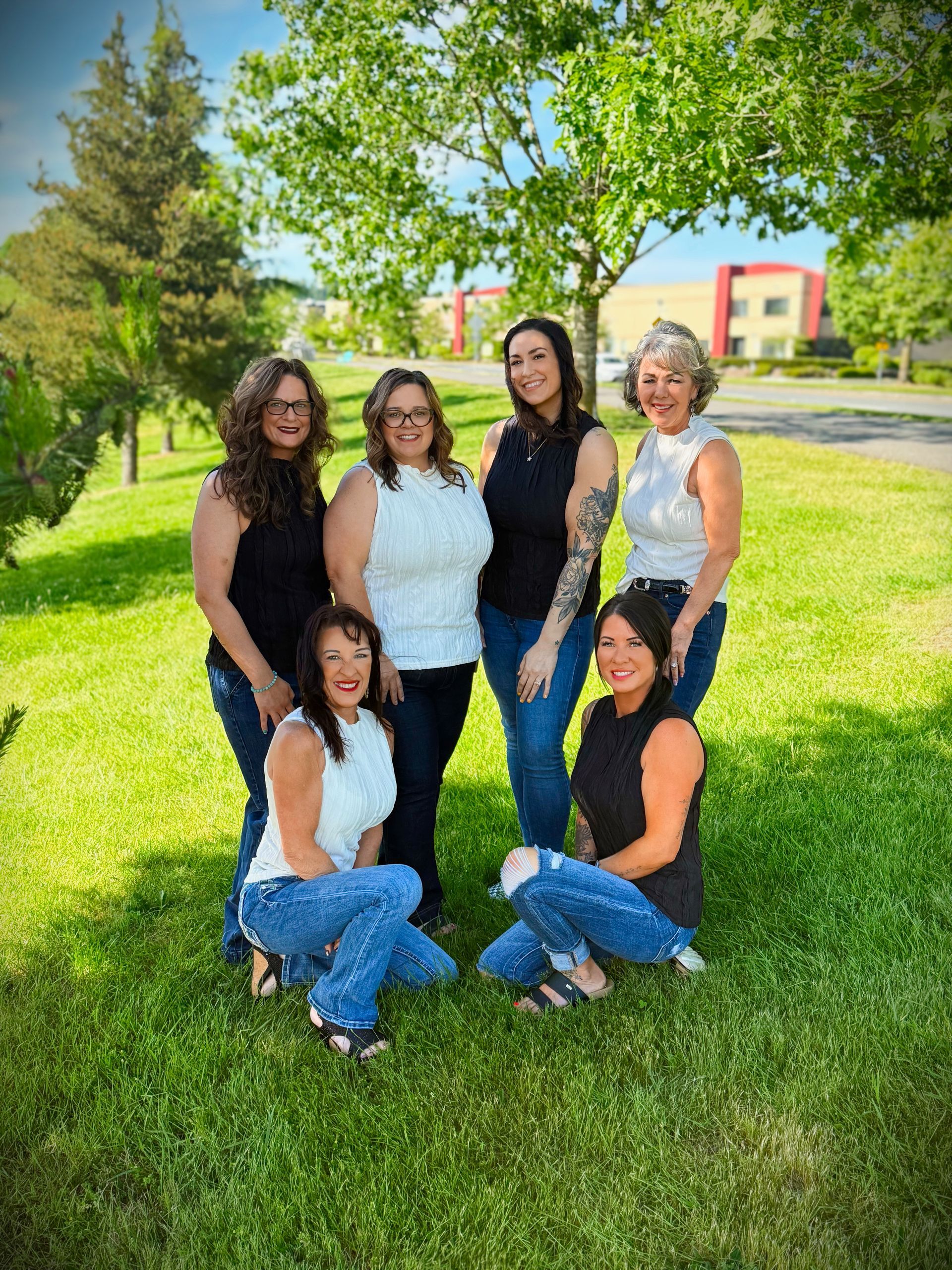 A woman with long brown hair is wearing a black cape.