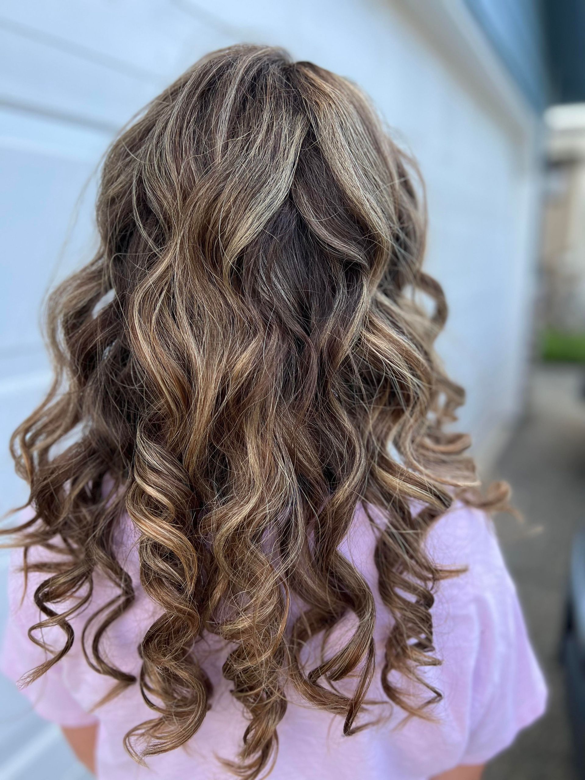 A close up of a girl 's hair with glitter on it.