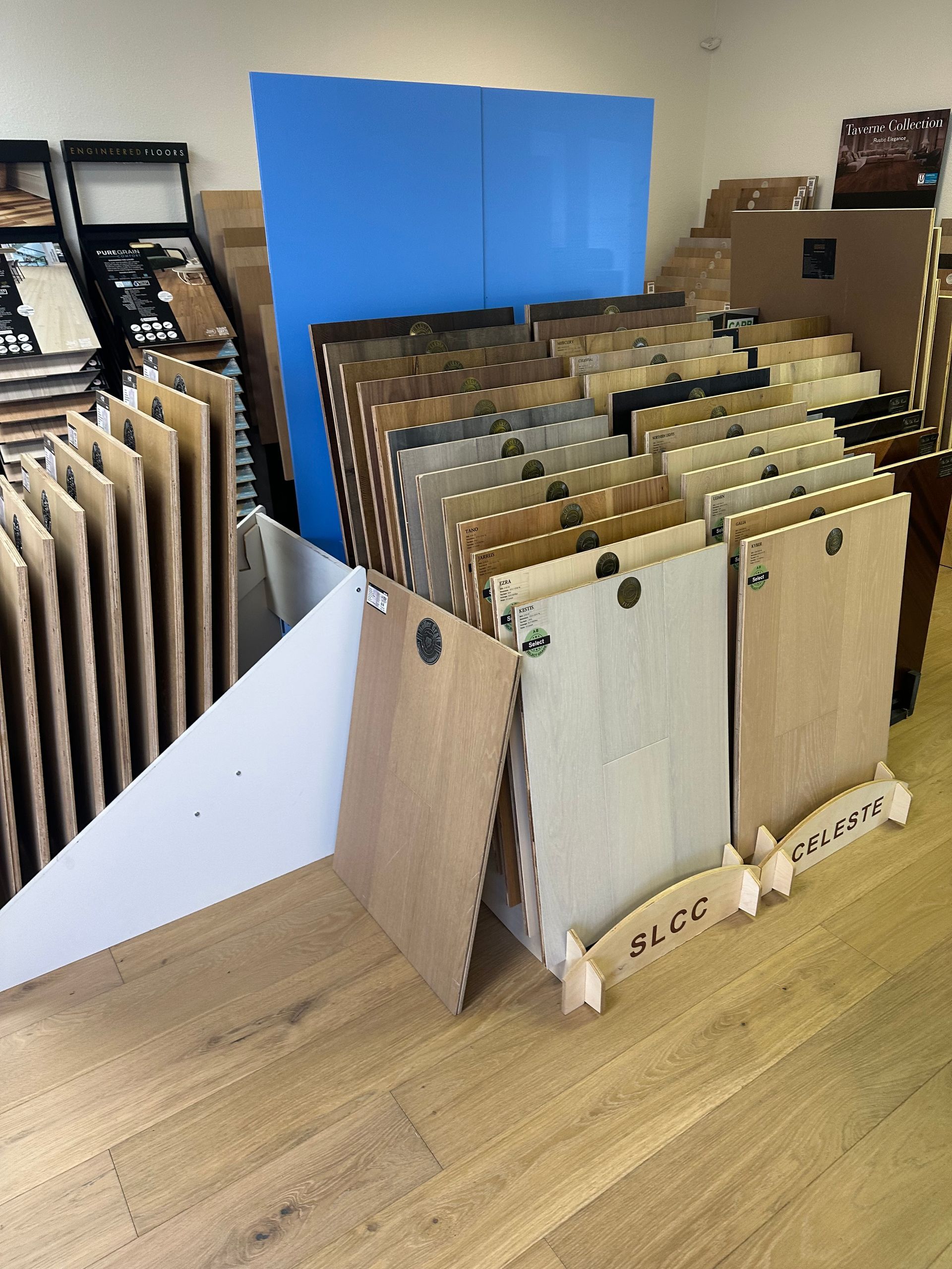 Flooring samples displayed in a store, showcasing various wood tones.