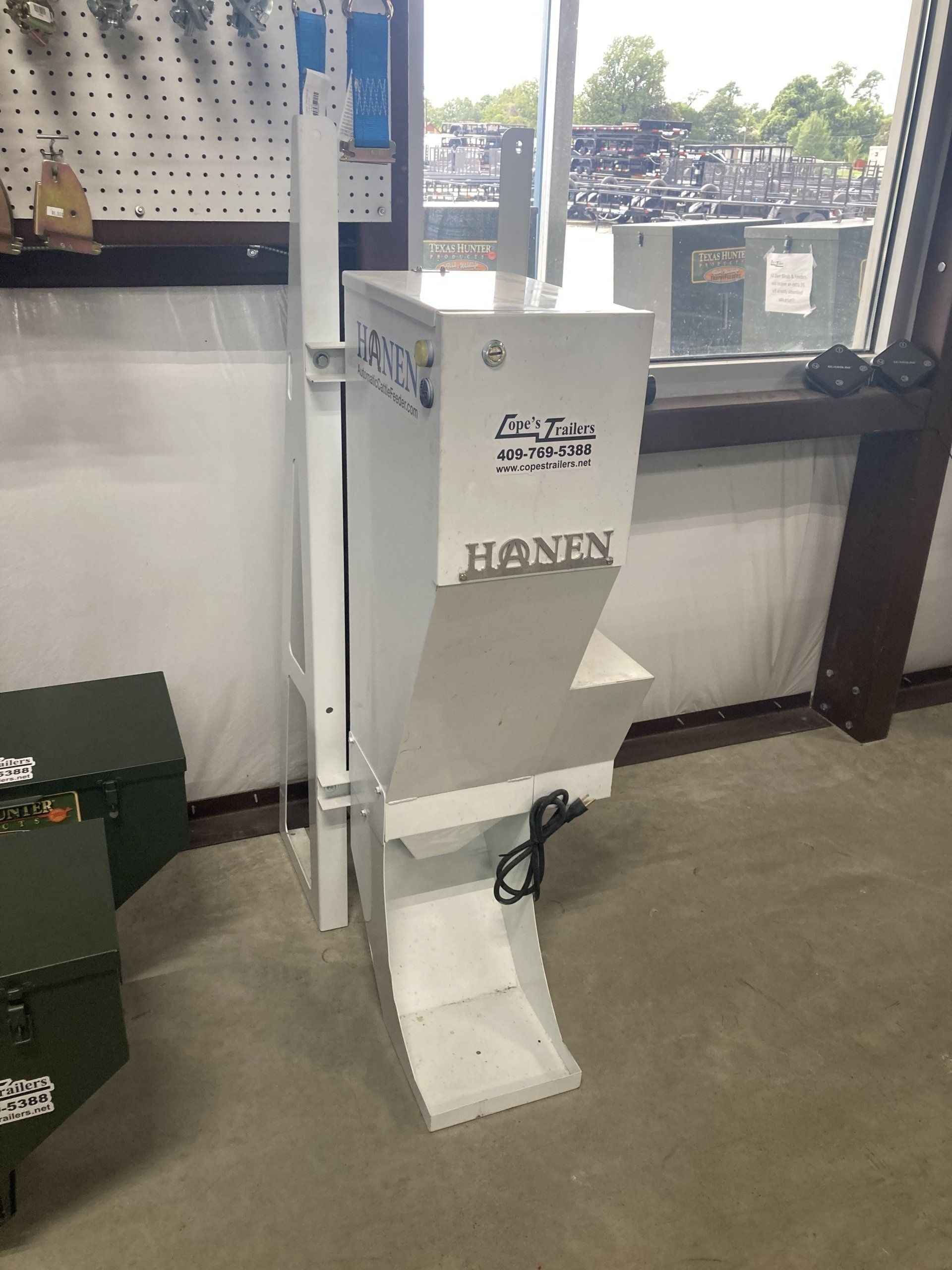 A white machine is sitting in a room next to a window.