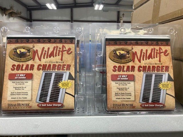 Two boxes of wildlife solar chargers are sitting on a shelf.