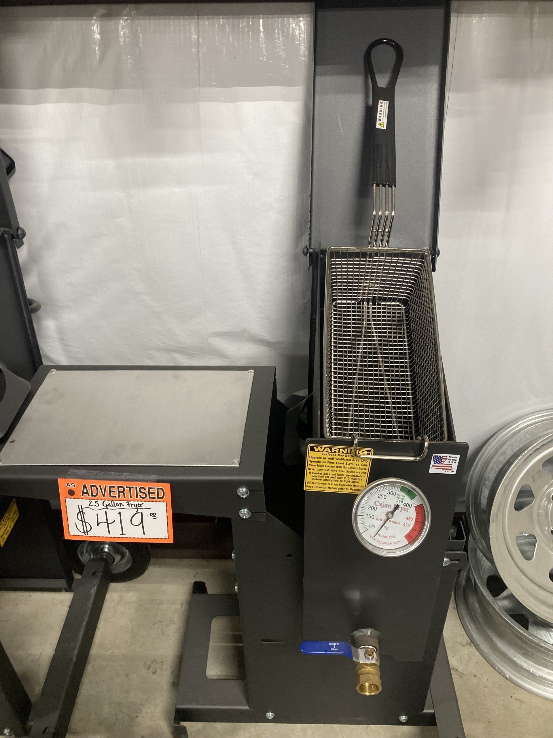 A machine with a gauge on it is on display in a garage