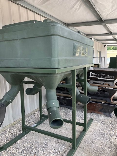 A green container is sitting on top of a metal stand