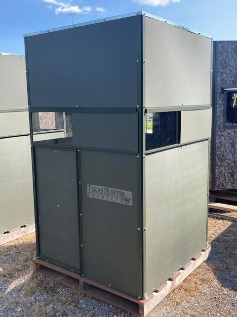 A green building is sitting on top of a wooden pallet.