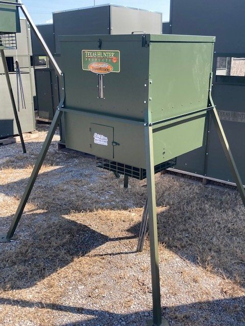 A green box is sitting on top of a pile of dirt.
