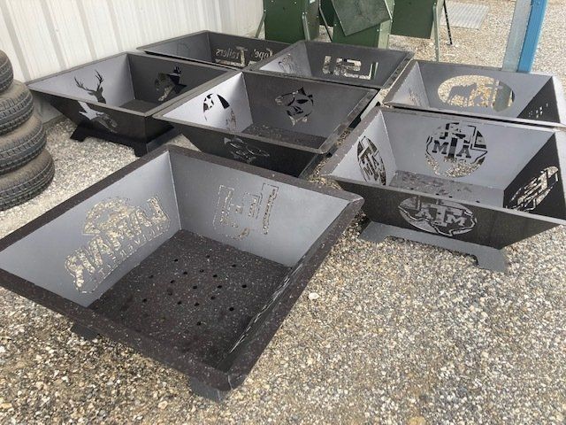 A group of fire pits are sitting on the ground.