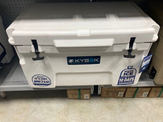 A white cooler is sitting on a shelf in a store.