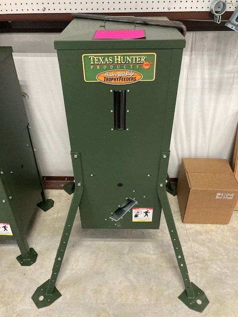 A green texas hunter feeder is sitting on the floor