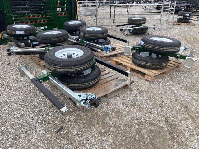 A bunch of tires are stacked on top of each other on pallets.