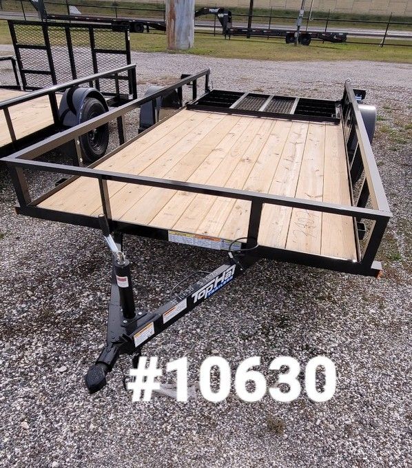 Black utility trailer with wooden deck on gravel, with a #10630 graphic.