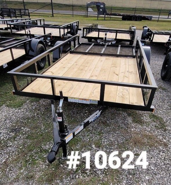 Black utility trailer with wooden bed, on display.