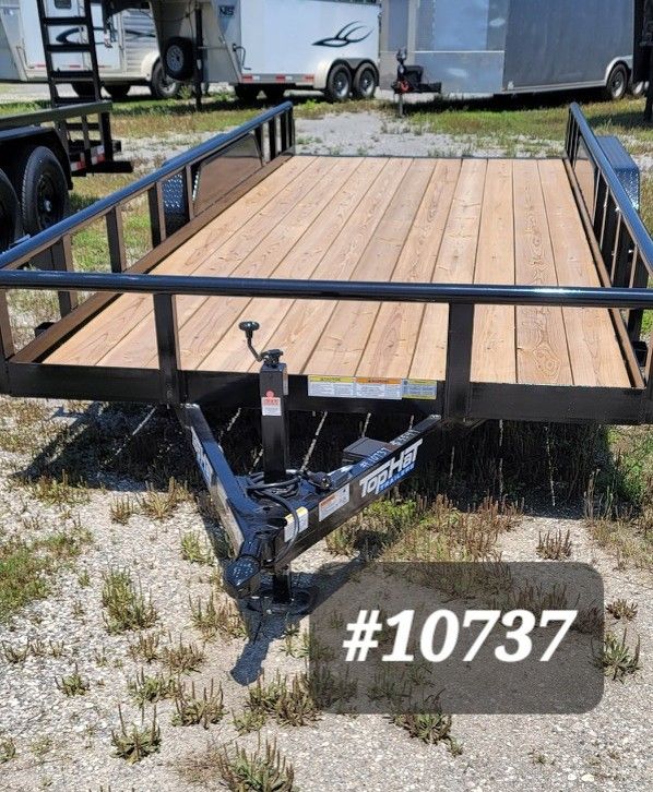 Wooden flatbed utility trailer with black rails and hitch, parked outdoors, labeled #10737