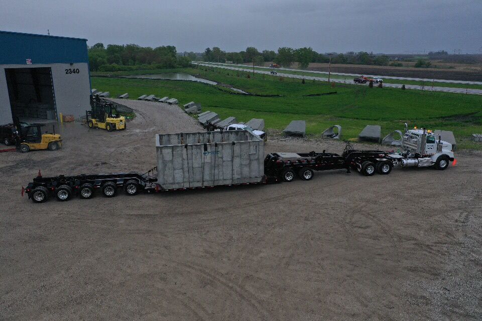 A semi truck is carrying a large container on a trailer