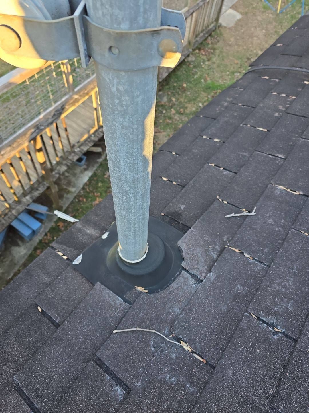 Roof with a metal vent pipe and flashing.