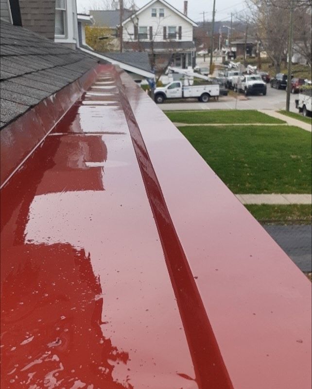 A red gutter with a white truck parked in the background