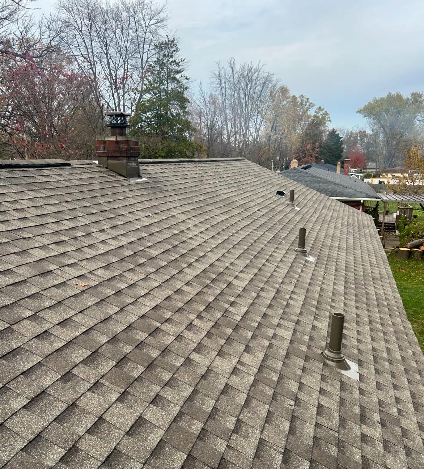 A close up of a roof with a chimney on it.