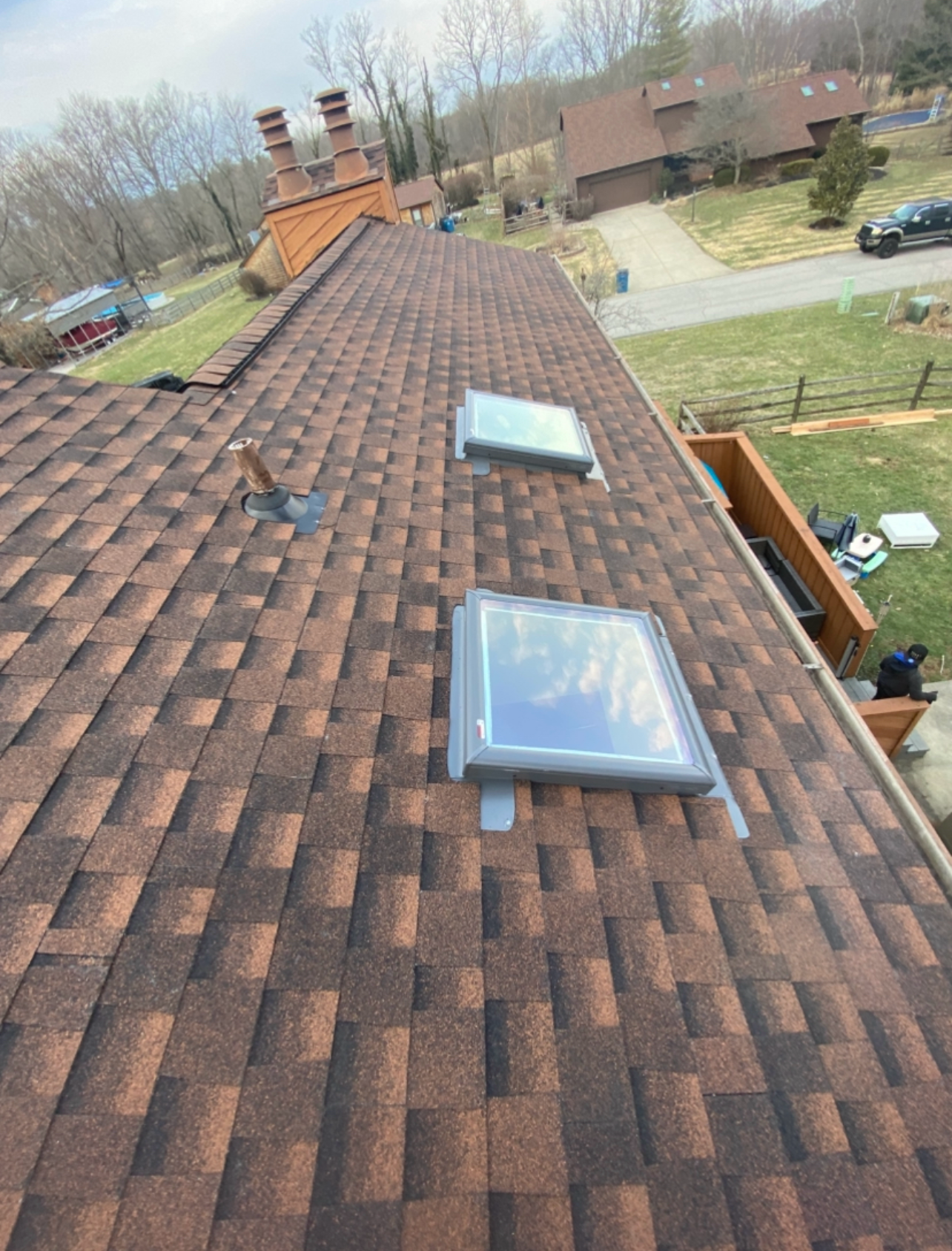 There are two skylights on the roof of a house.