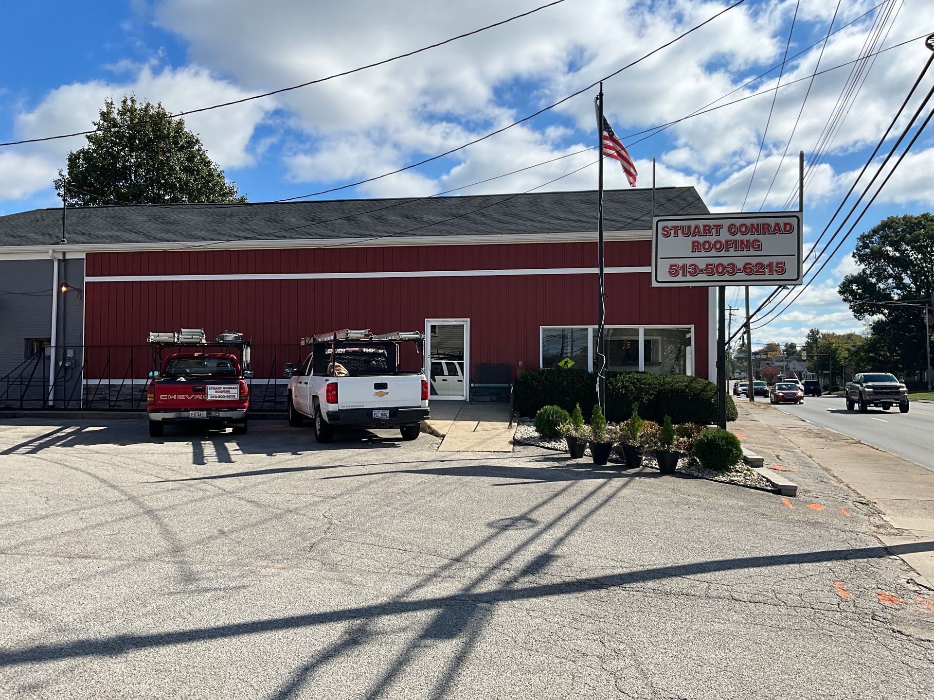 A red building with a white truck parked in front of it
