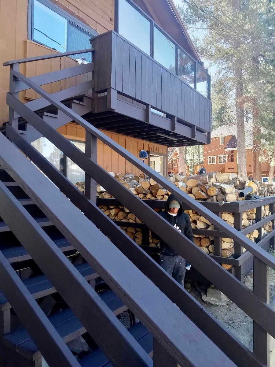 A man is walking up a set of stairs to a balcony